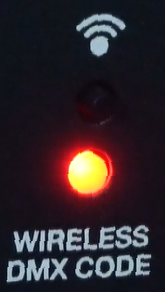 A vertical section of a black control panel labeled "WIRELESS DMX CODE" at the bottom, featuring a illuminated red indicator light and a Wi-Fi signal icon at the top.