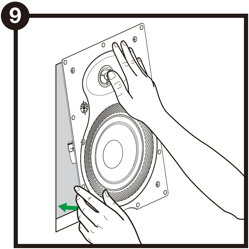A technical line drawing labeled with the number 9 in a black circle at the top-left corner demonstrates inserting the speaker into the wall:  Insertion Action: Two hands guide a rectangular in-wall speaker frame into a cutout in the drywall surface.  Directional Indicator: A green arrow near the bottom edge points inward toward the wall, indicating pushing the speaker body into the rectangular opening.  Speaker Features: The front face of the speaker shows a top directional tweeter being pressed/guided by a hand, a main woofer cone below it, an adjustable tap switch dial on the left side, and multiple mounting screw holes around the outer frame flange.