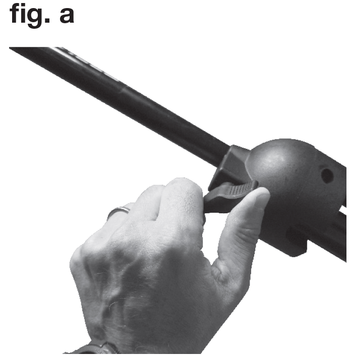 A black-and-white instructional photo labeled "fig. a" in the upper-left corner showing manual operation of a stand adjustment lever:  Component: A black tubular metal stand shaft running diagonally across the frame, fitted with a rounded plastic housing collar.  Action: A person's hand grips the housing with their thumb resting on a ribbed quick-release lock lever, demonstrating how to engage or disengage the clamping mechanism to adjust the stand's extension or angle.